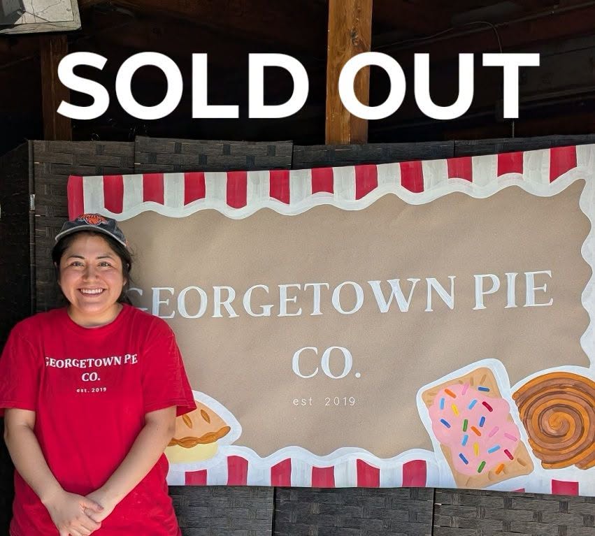 Chef Karina in front of the Georgetown Pie Co sign at the sold-out Barking Armadillo Brewing Co. pop-up